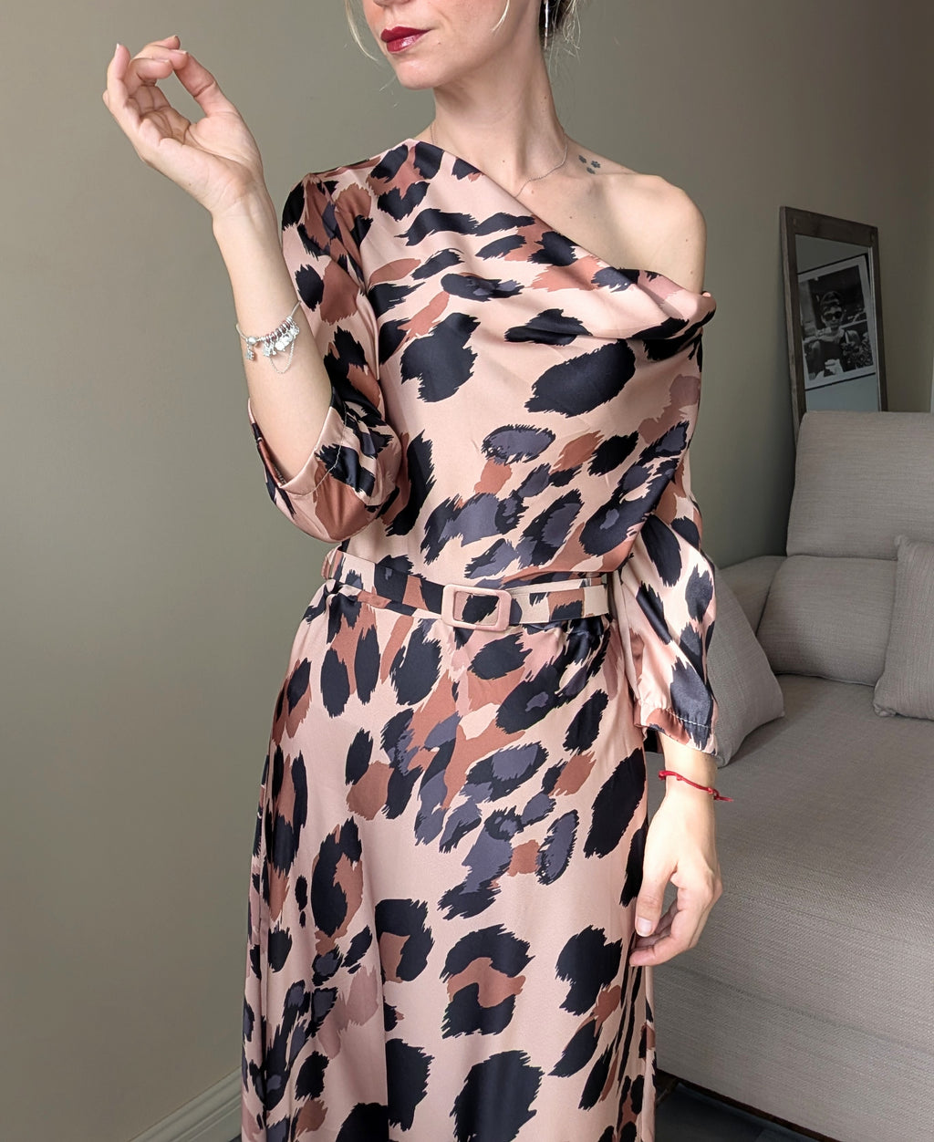 Vestido satinado animal print con escote colocado sobre un hombro y cinturón a juego.